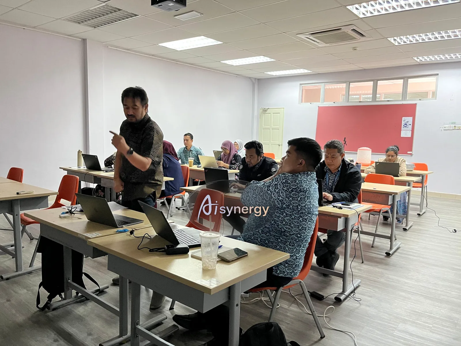 Trainer moving between desks giving individual guidance during a hands-on session