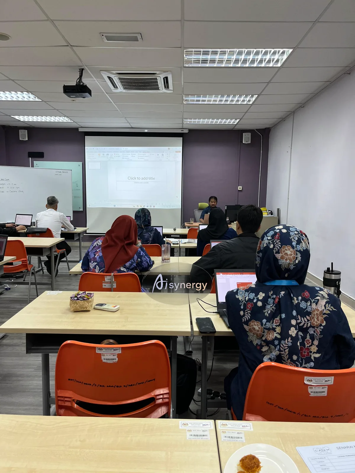 Small group of professionals working at laptops during a training session