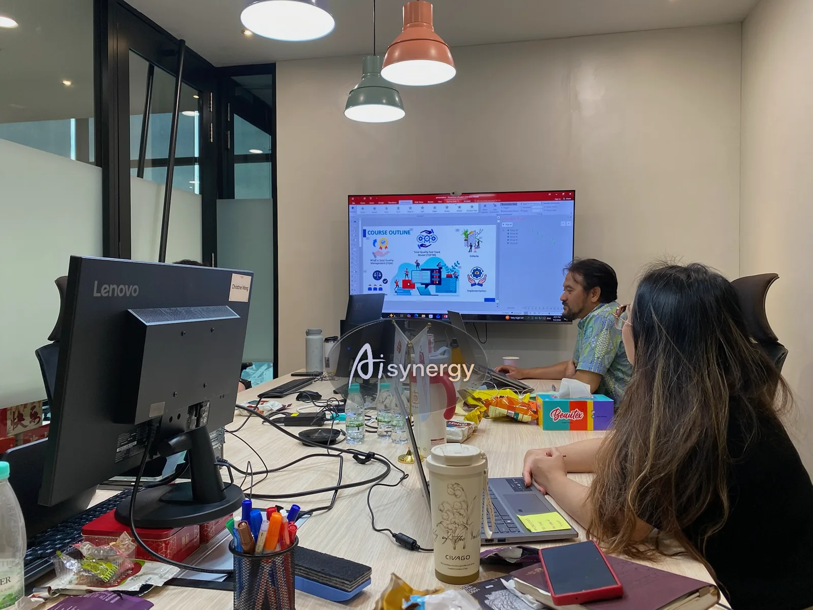 Two colleagues reviewing work together on a shared screen during a working session
