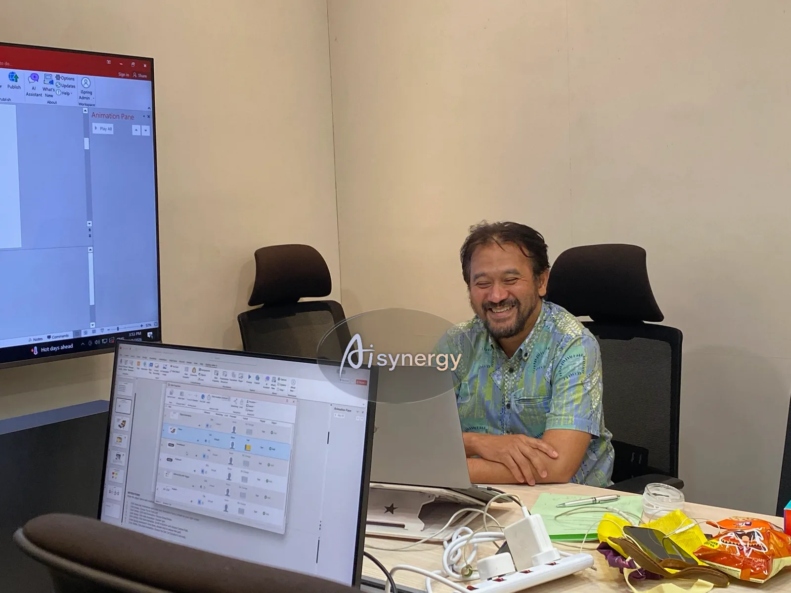 AISynergy trainer working through a task at a laptop during a small-group session