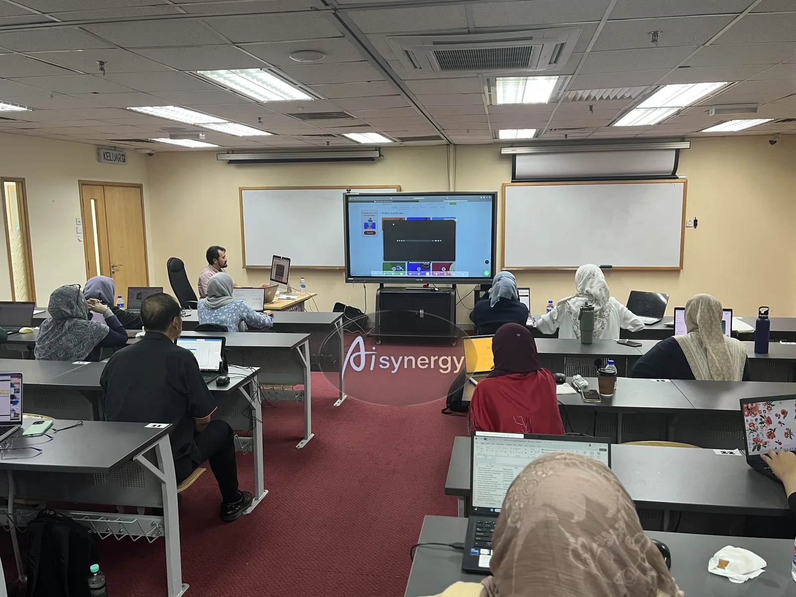 Participants working along on their own laptops during a hands-on session